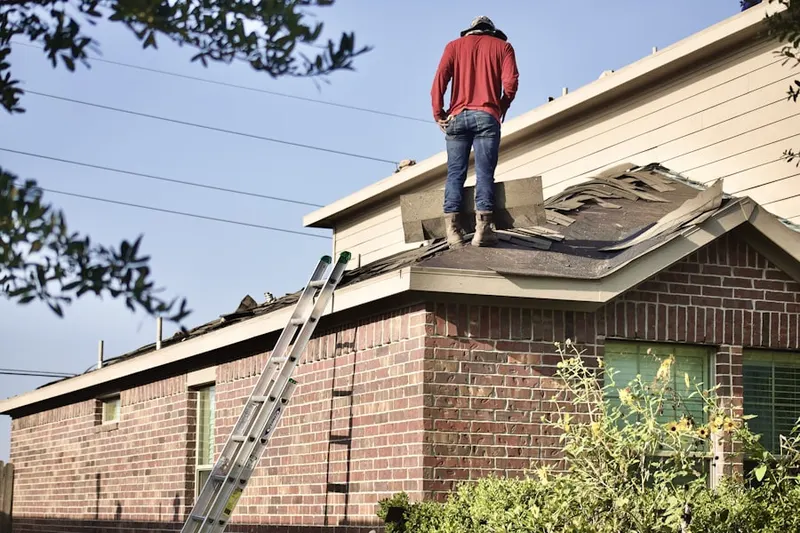 Professional roofer working on a residential roof in Maple View